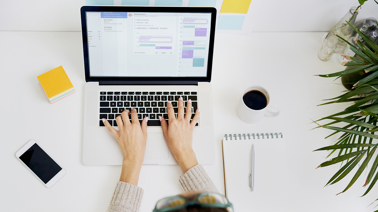 Young woman working at desk with laptop